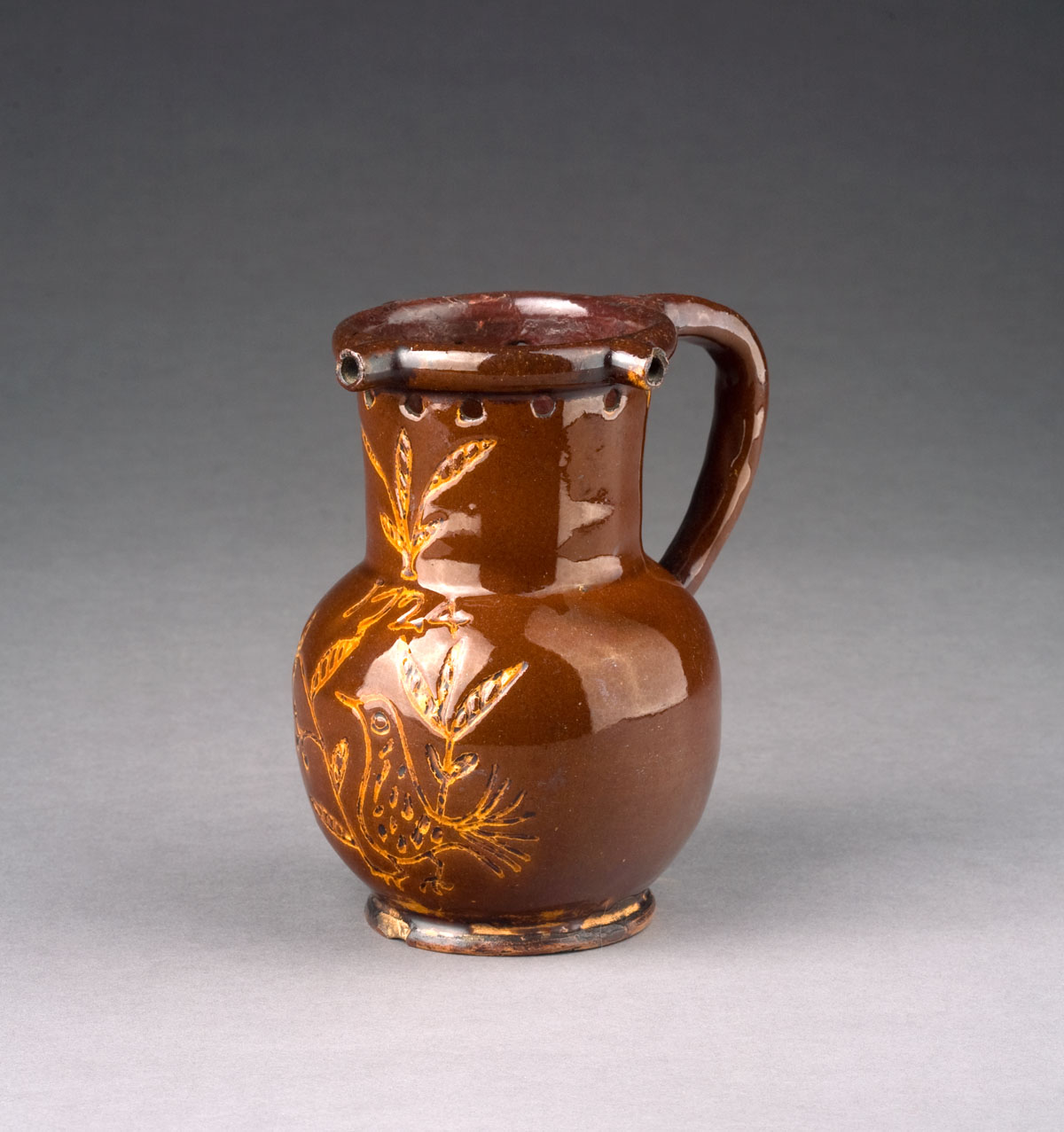 Appraisal: ENGLISH GLAZED REDWARE PUZZLE JUG DATED Covered in a brick