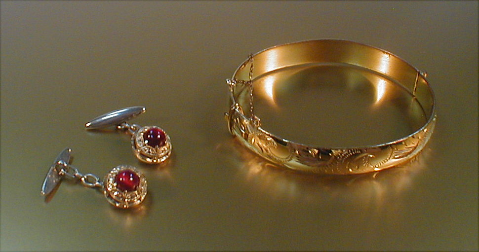 Appraisal: A hinged rolled gold bangle together with a pair of