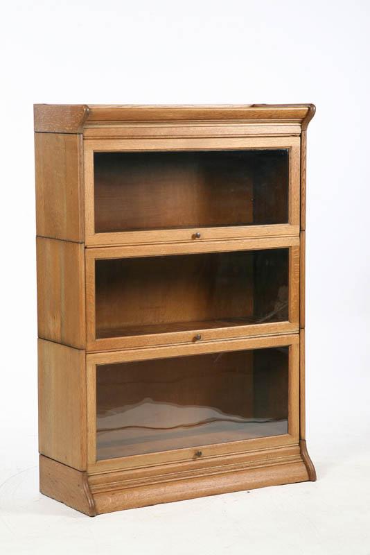 Appraisal: STACKED BOOKCASE Oak three section case with glazed lift doors