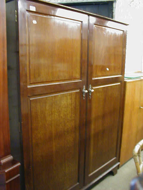 Appraisal: A Compactom Limited patent no mahogany two door wardrobe with