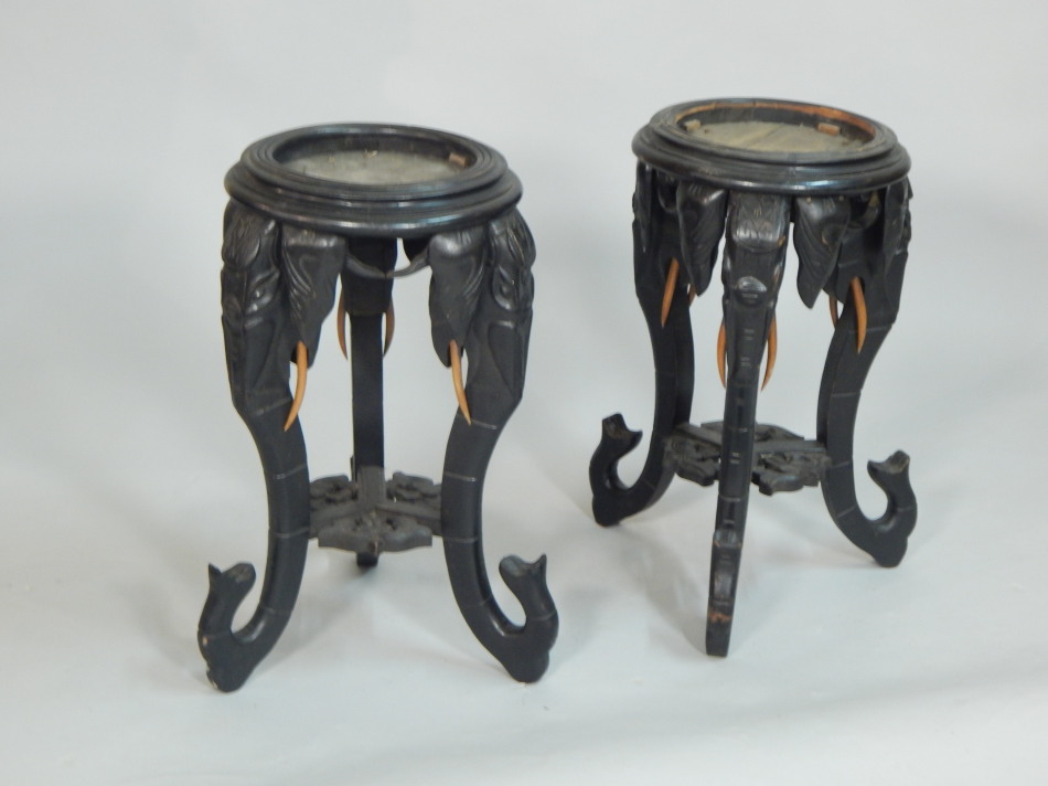 Appraisal: A pair of Indian ebonised jardiniere stands each leg carved