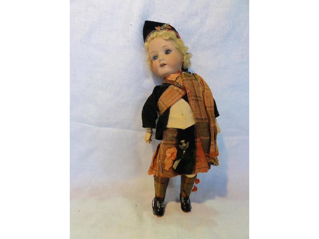 Appraisal: A doll in the form of a curly haired Scotsman