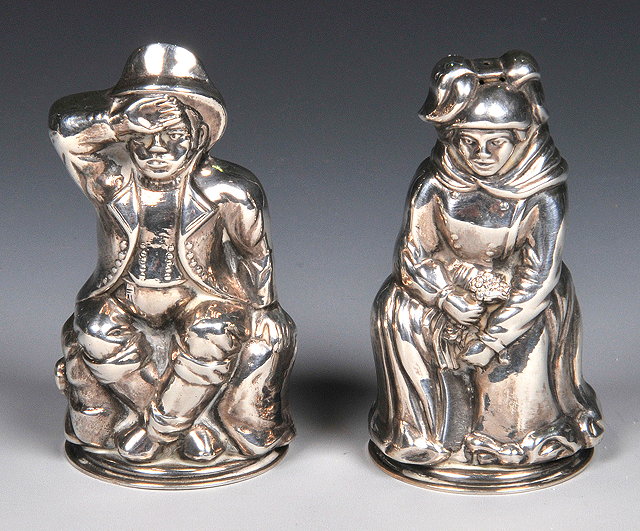 Appraisal: A PAIR OF SILVER 'COUNTRY FIGURE' SHAPED SALT AND PEPPER