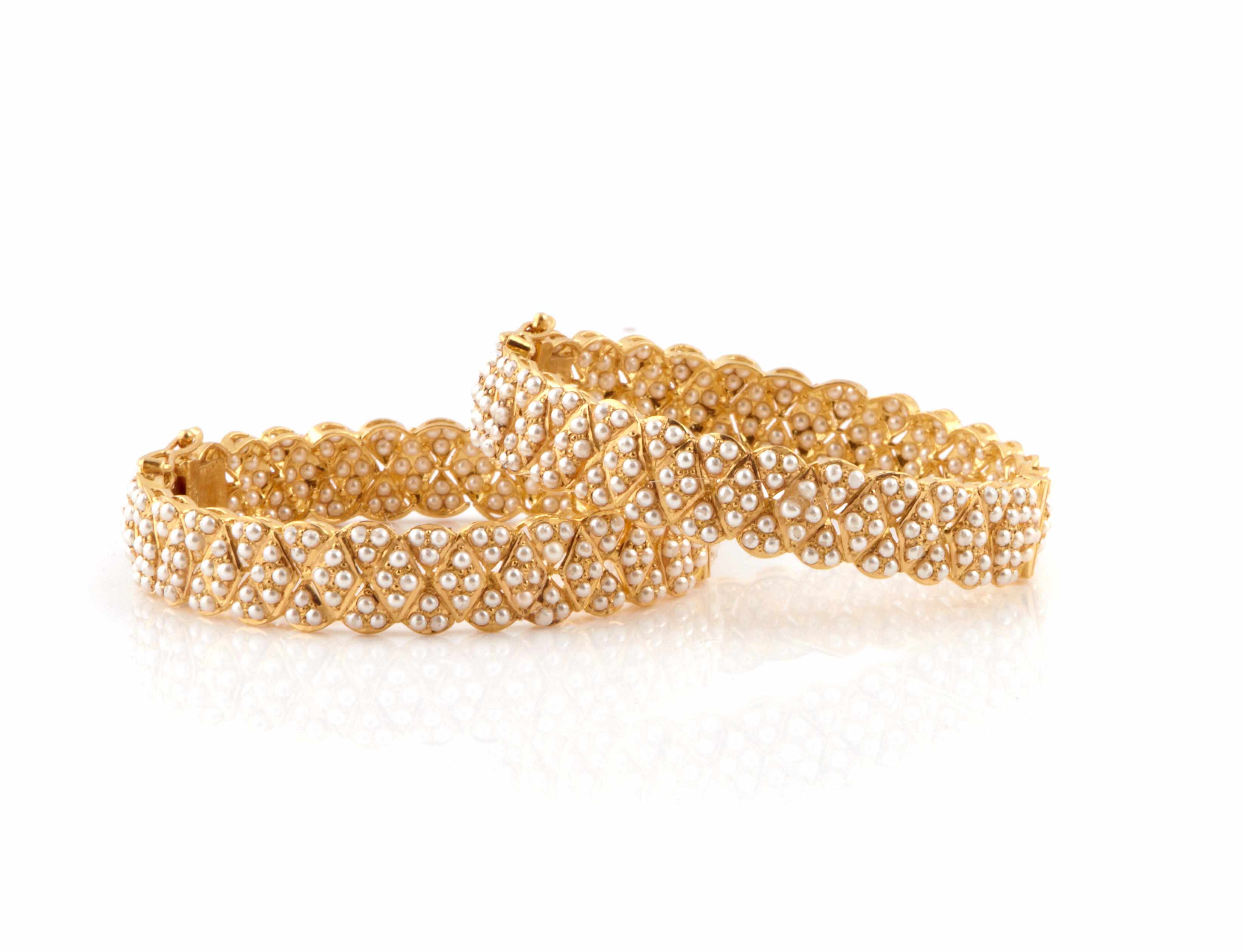 Appraisal: A pair of seed pearl and k gold bangles g