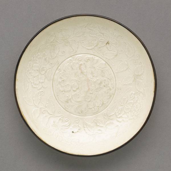 Appraisal: A Dingyao saucer dish Jin Dynasty The vessel thinly molded