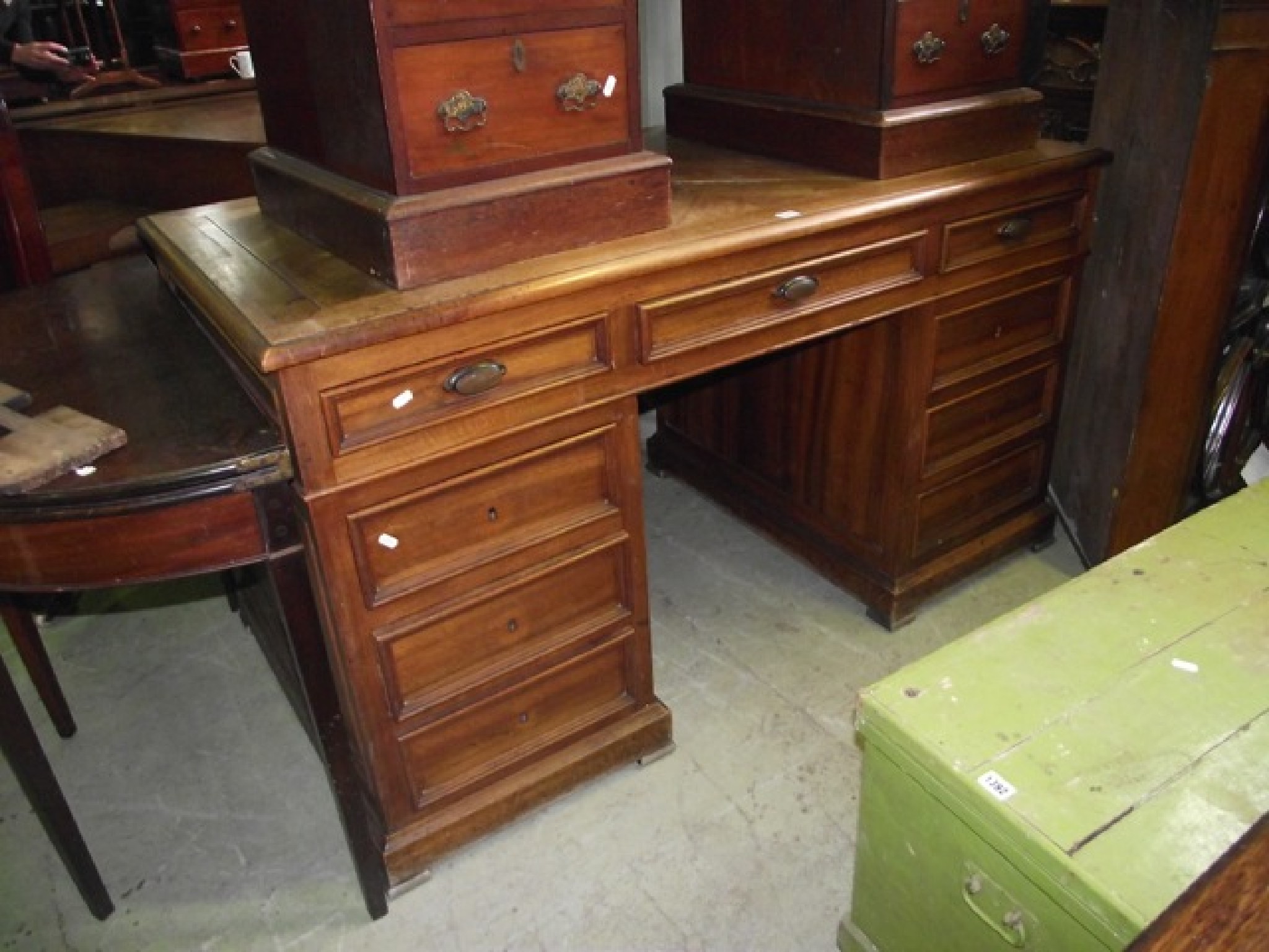 Appraisal: A walnut kneehole twin pedestal desk with well-matched veneered top