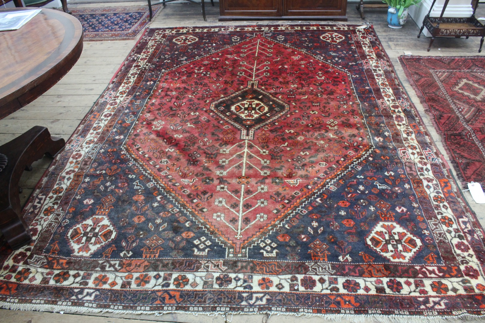 Appraisal: A modern Shiraz carpet with a red and blue ground