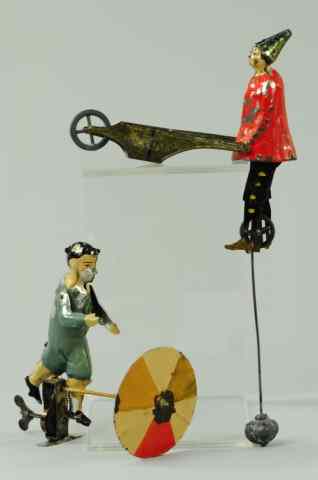 Appraisal: BOY WITH UMBRELLA AND CLOWN PUSHING WHEELBARROW Germany hand painted