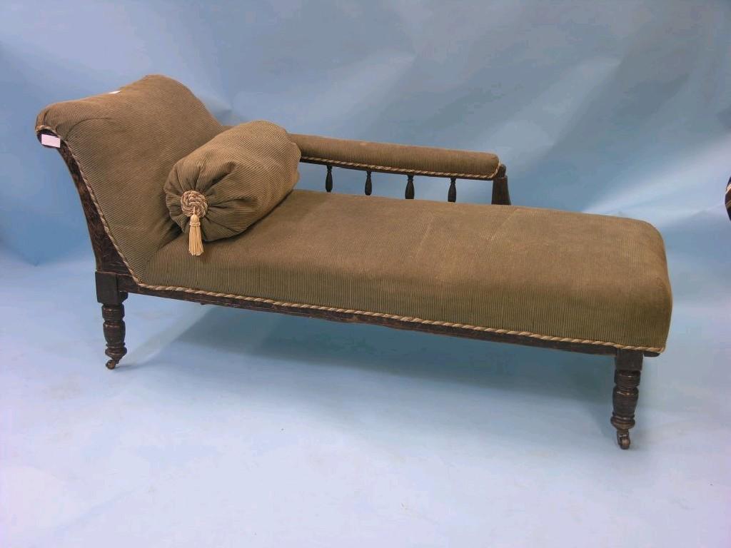 Appraisal: A Victorian walnut-framed chaise longue with spindle-turned gallery upholstered in