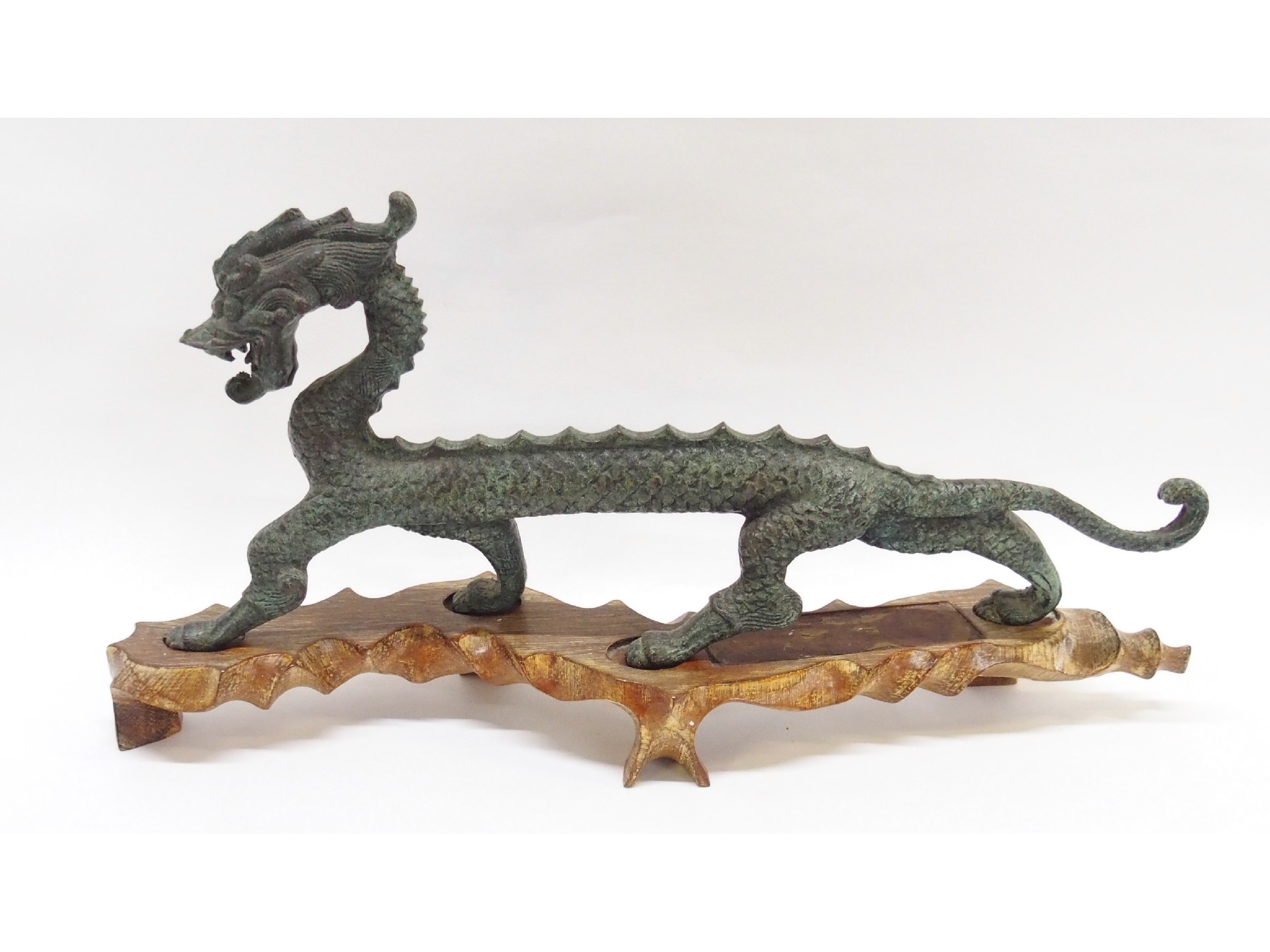 Appraisal: Chinese oxidised metal figure of a dragon on carved wood