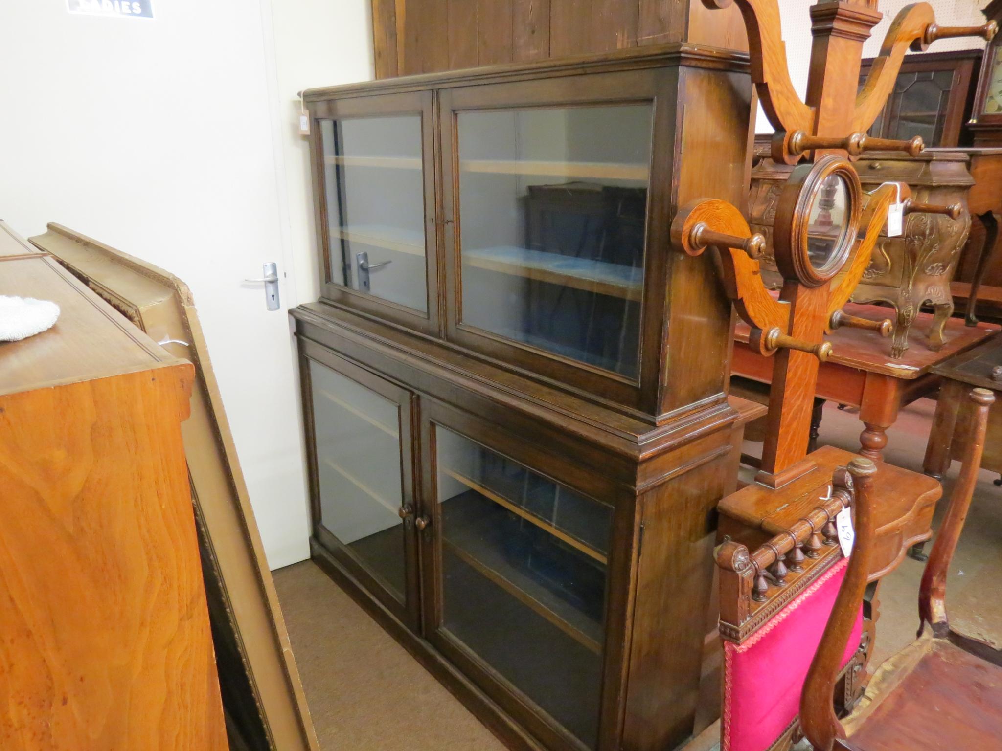 Appraisal: A Victorian oak bookcase in two sections lined shelves enclosed