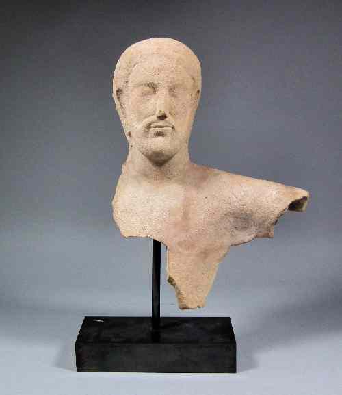 Appraisal: An ''Archaic'' terracotta bust of a bearded man on modern