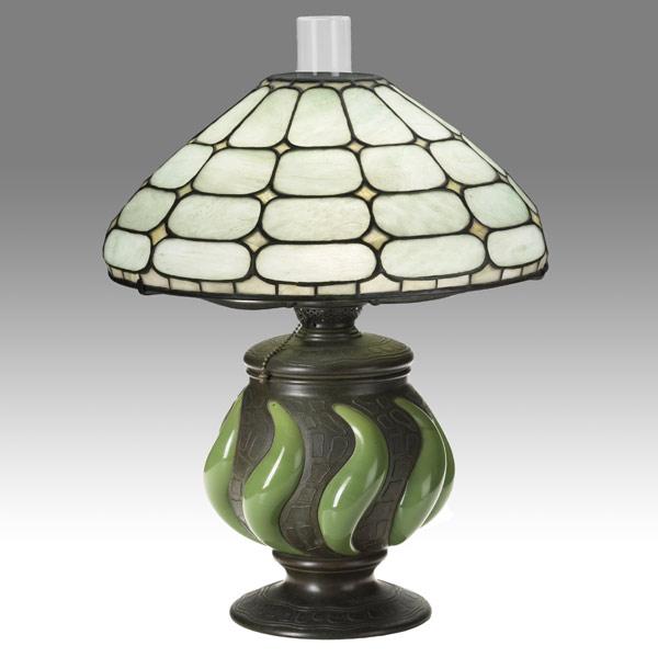 Appraisal: TIFFANY STUDIOSColonial table lamp with blown out patterned bronze base