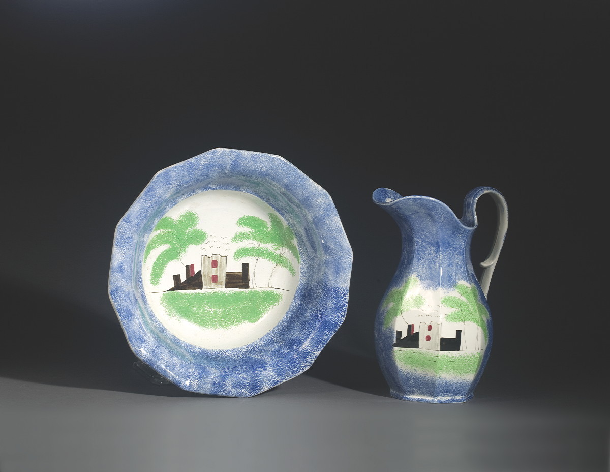 Appraisal: STAFFORDSHIRE BLUE SPATTERWARE 'CASTLE' PATTERN WATER PITCHER AND A BASIN