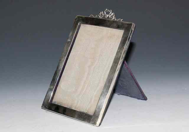 Appraisal: AN EDWARDIAN SILVER RECTANGULAR PORTRAIT FRAME with ribbon and swag