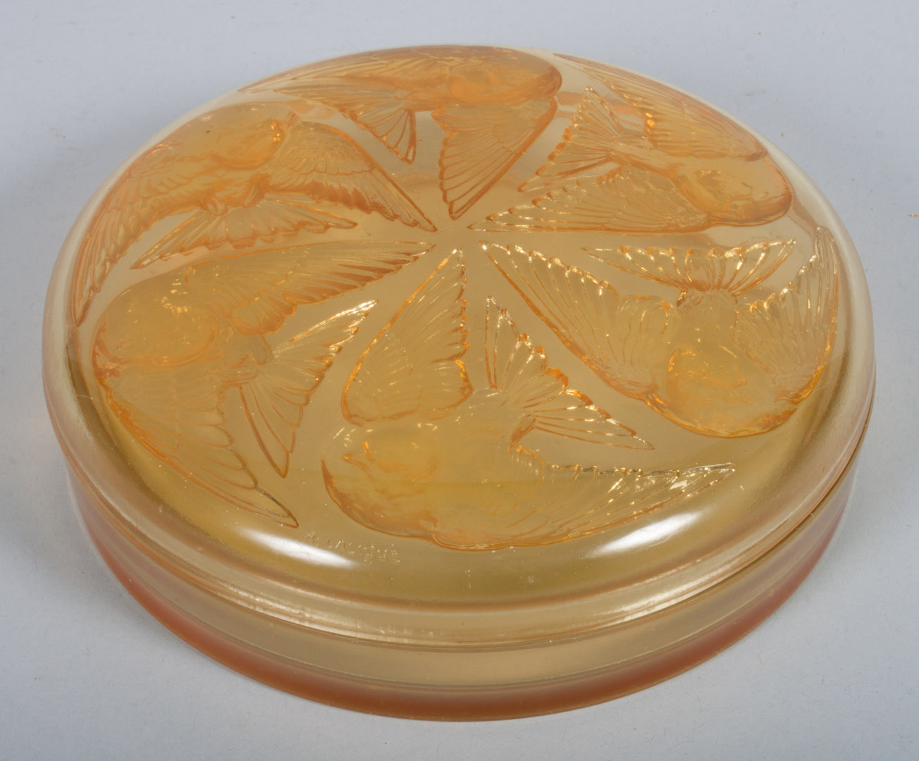 Appraisal: Continental amber glass powder box bird relief decoration on lid