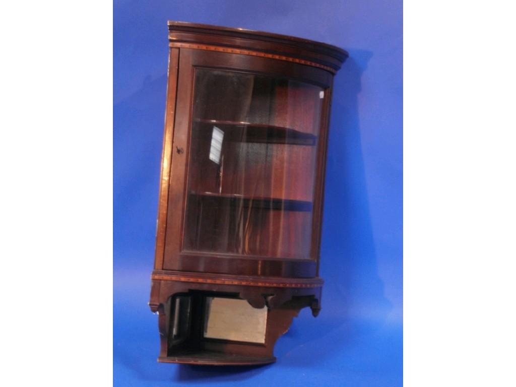 Appraisal: A late thC inlaid mahogany bow-fronted hanging corner cupboard with