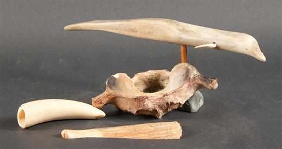 Appraisal: Inuit carved bone dolphin animal vertebra whale tooth and a