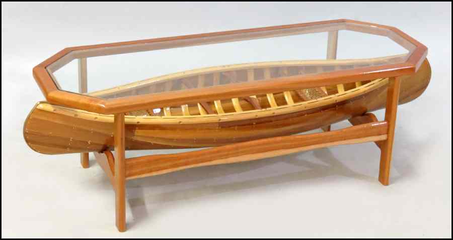 Appraisal: GLASS TOP COCKTAIL TABLE With a removeable canoe beneath the