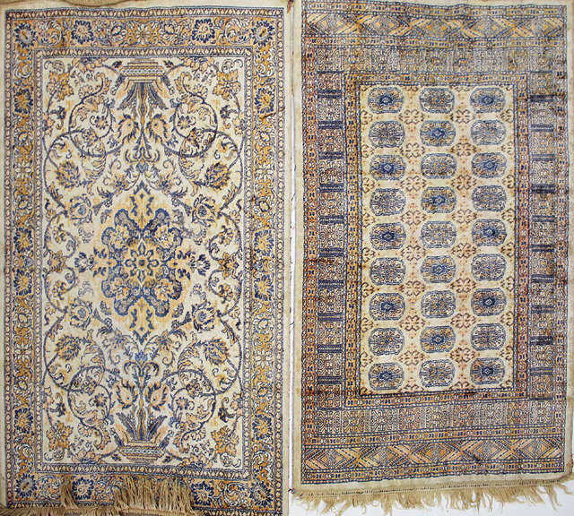 Appraisal: AN ANTIQUE SILK CREAM GROUND MAT with scrolling foliate field