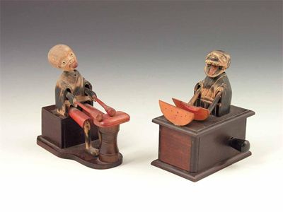 Appraisal: Two wooden automaton figures one playing a drum the other