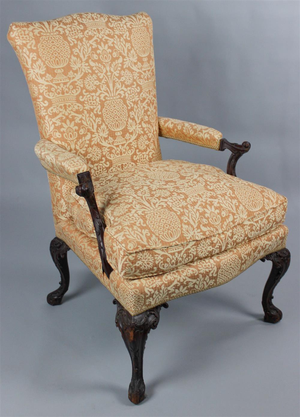 Appraisal: GEORGIAN STYLE CARVED OPEN ARM CHAIR the shaped crest rail