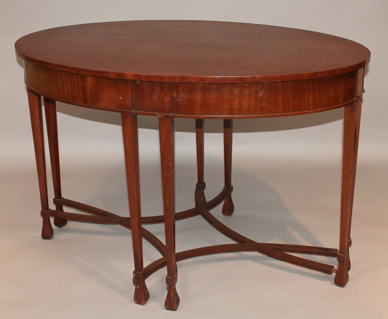 Appraisal: An Edwardian mahogany occasional table the oval top above square