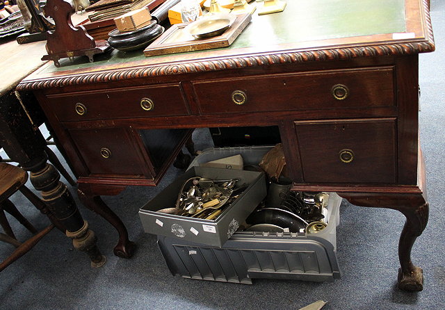 Appraisal: A WRITING DESK with green leatherette inset top gadrooned edge