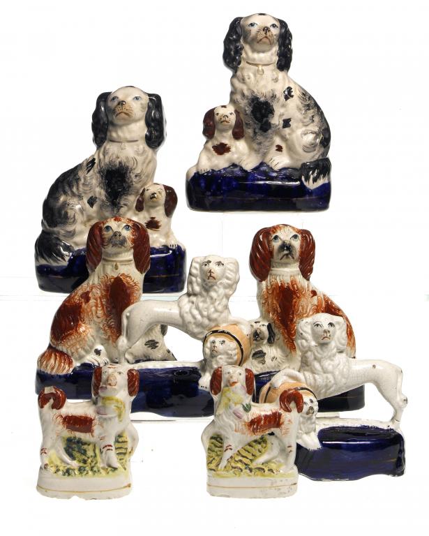 Appraisal: FOUR PAIRS OF STAFFORDSHIRE EARTHENWARE MODELS OF SPANIELS AND POODLES