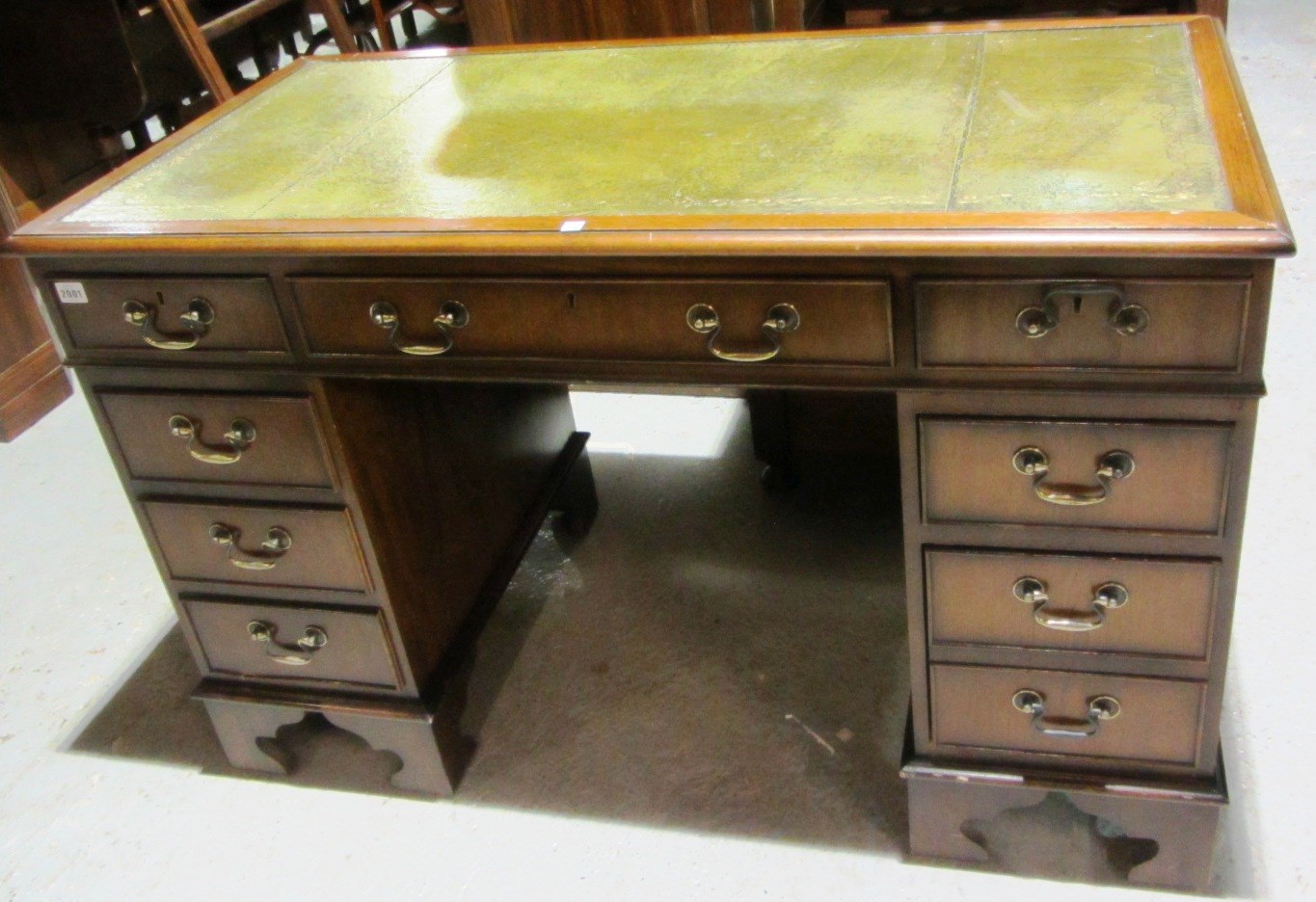 Appraisal: A reproduction mahogany twin pedestal desk with leather inset top