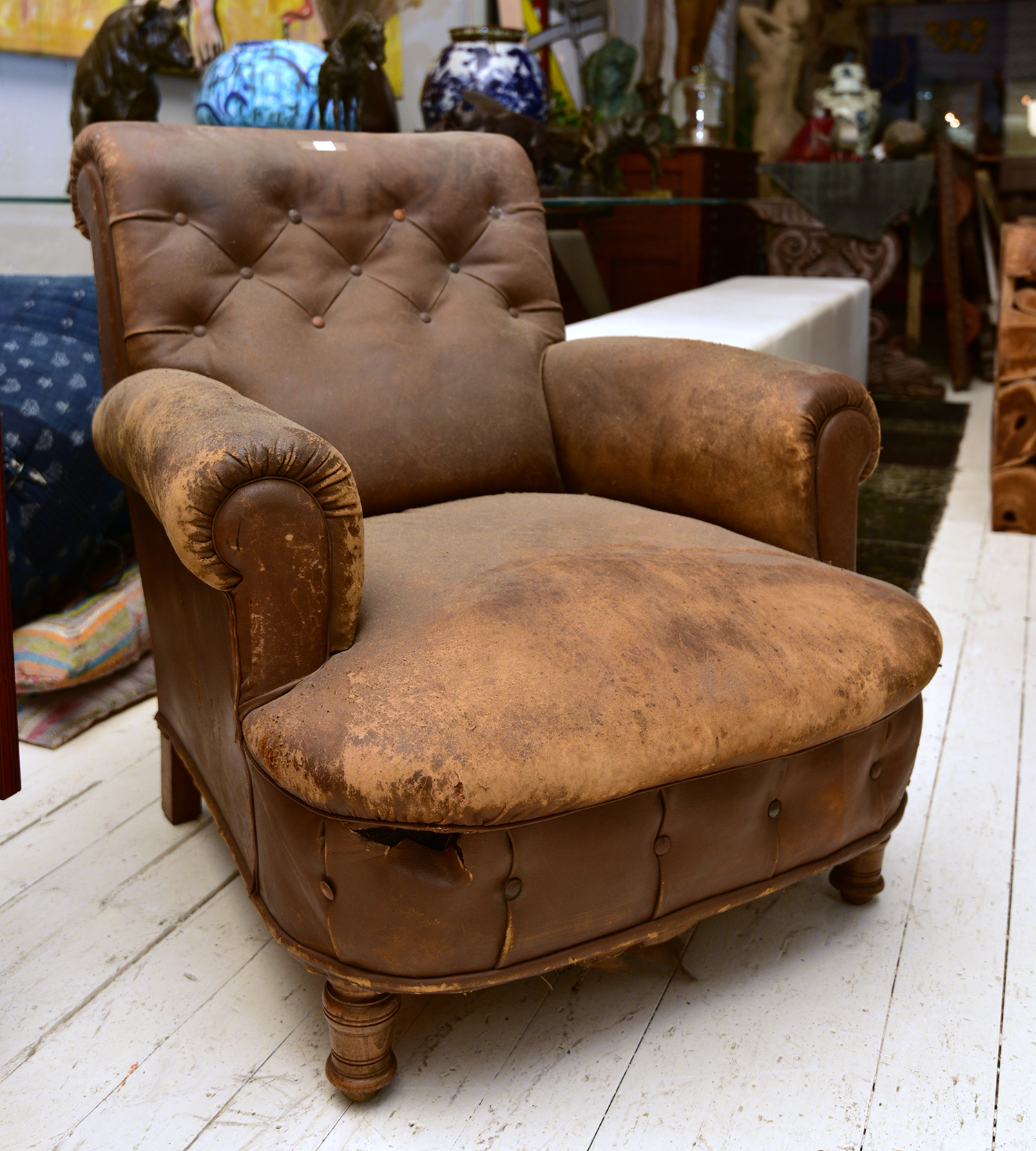 Appraisal: AN EARLY TH CENTURY ARM CHAIR IN DISTRESSED BROWN UPHOLSTERY