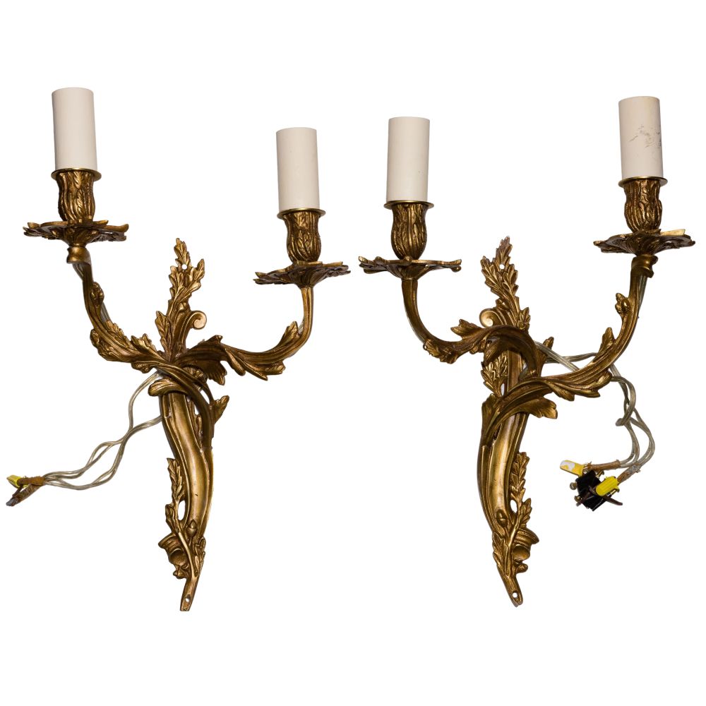 Appraisal: ROCOCO STYLE TWO-LIGHT SCONCESPair of -light metal sconces having a