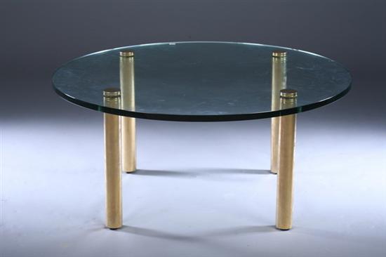 Appraisal: CONTEMPORARY ROUND COLORLESS GLASS-TOP LOW TABLE Four cylindrical brass legs