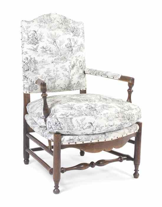 Appraisal: A Provincial Style Upholstered Armchair having upholstered back arms and