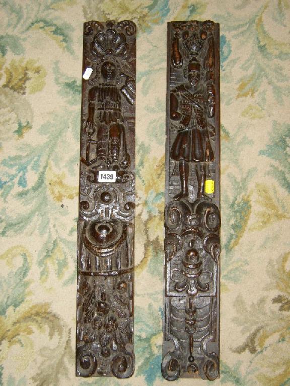 Appraisal: A similar pair of period oak panels detailing characters in