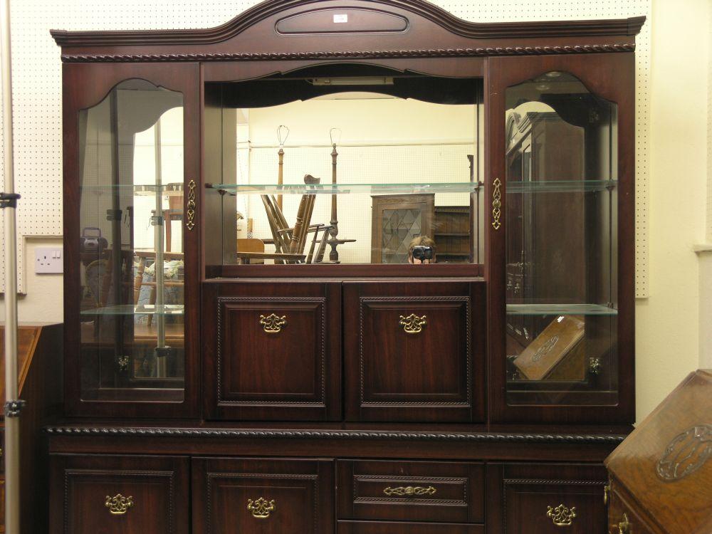 Appraisal: A reproduction mahogany finished wall unit pair of glazed doors