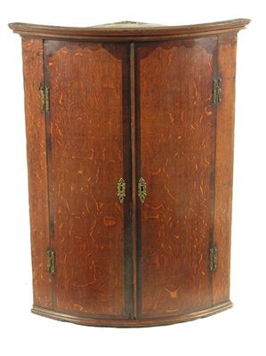 Appraisal: A George III oak and mahogany banded bowfront hanging corner