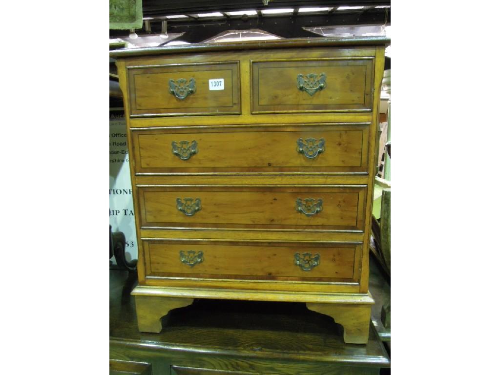 Appraisal: A small reproduction yew wood veneered chest in the Georgian