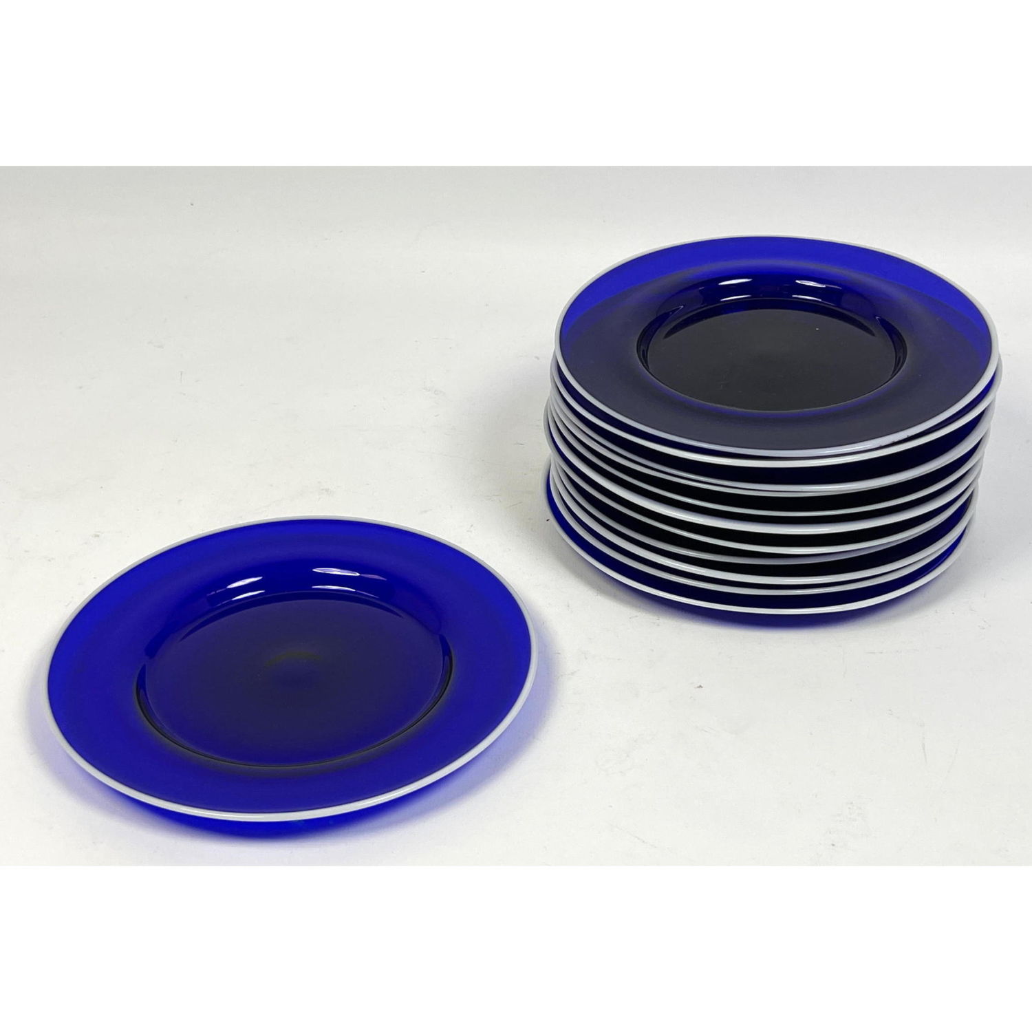 Appraisal: Set of hand blown blue glass plates with white edge