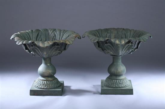 Appraisal: PAIR CAST IRON JARDINIERES Circular leafy basin on baluster pedestal