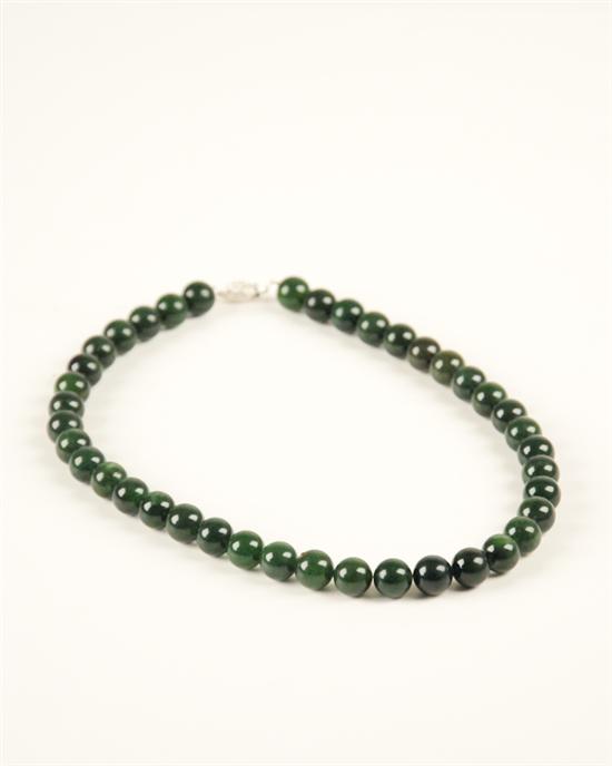 Appraisal: A Green Jade Bead Necklace the beads mm with a