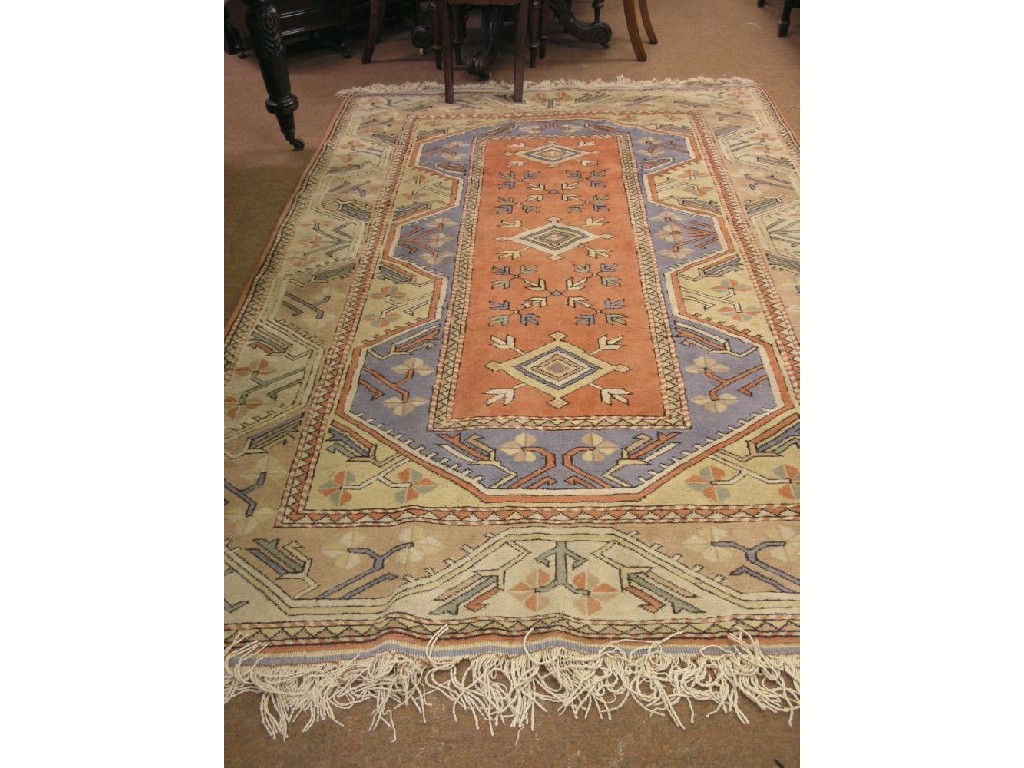 Appraisal: A Turkish wool rug geometric devices predominantly in peach pale