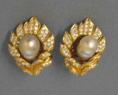 Appraisal: A PAIR OF PEARL AND DIAMOND EARRINGS modelled as a