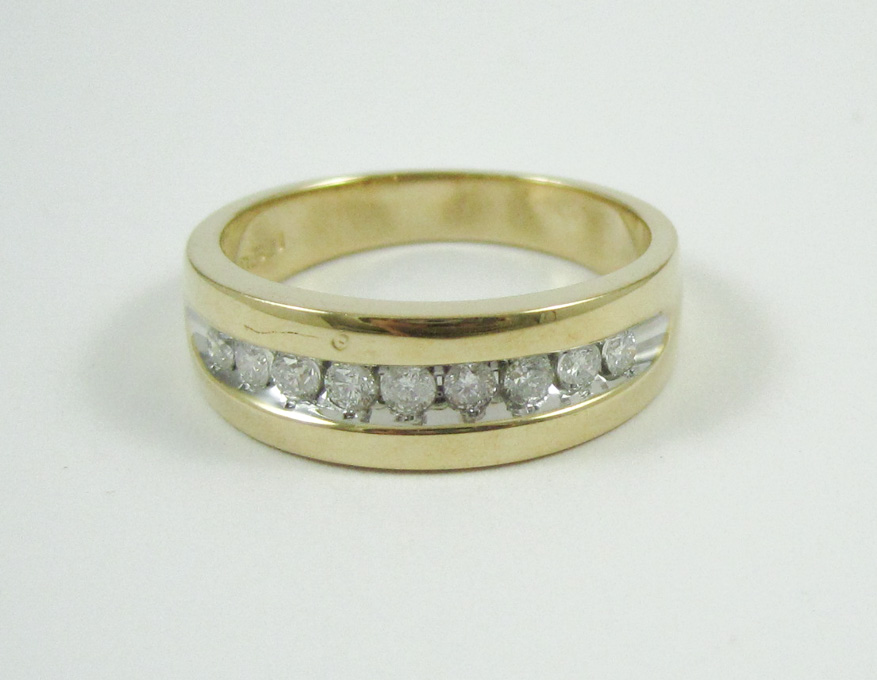 Appraisal: MAN'S DIAMOND AND FOURTEEN KARAT GOLD RING with a row