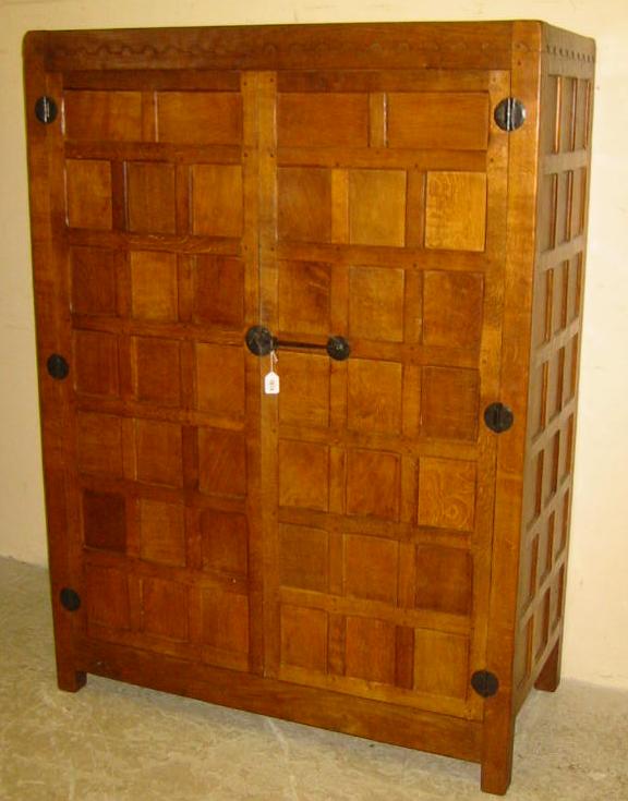 Appraisal: AN OAK WARDROBE by Robert Mouseman Thompson of multi panel