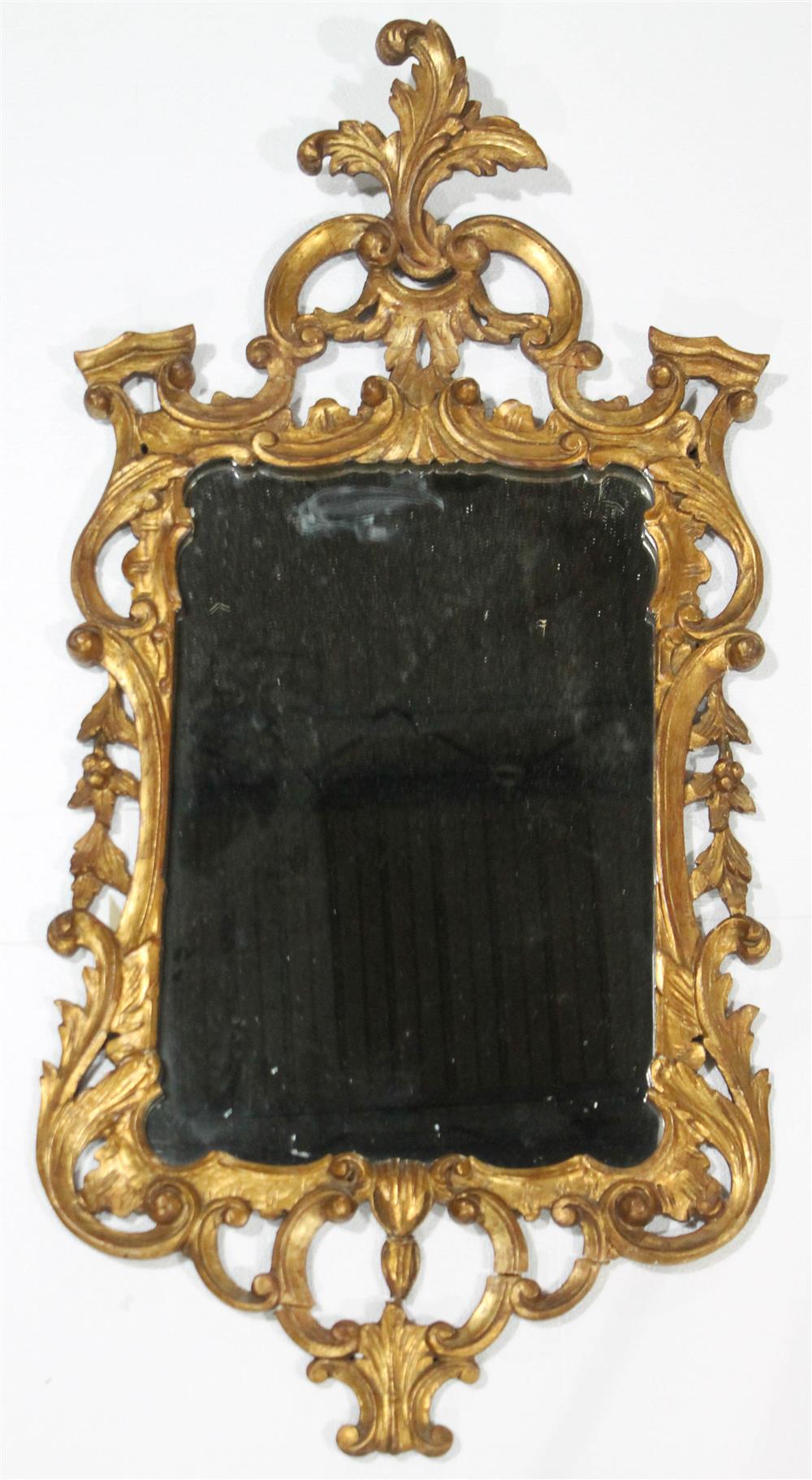 Appraisal: CHIPPENDALE STYLE CARVED AND GILDED MIRROR having a carved and