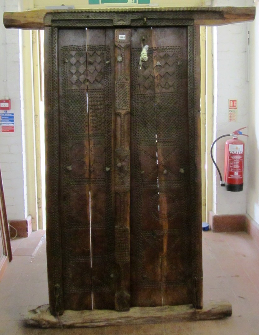 Appraisal: An Omani carved hardwood door and frame surround with chip