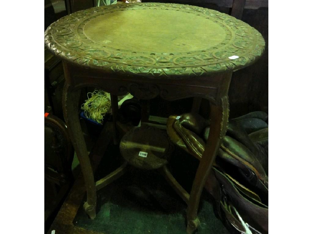 Appraisal: An Edwardian oak occasional table the circular overhanging top with