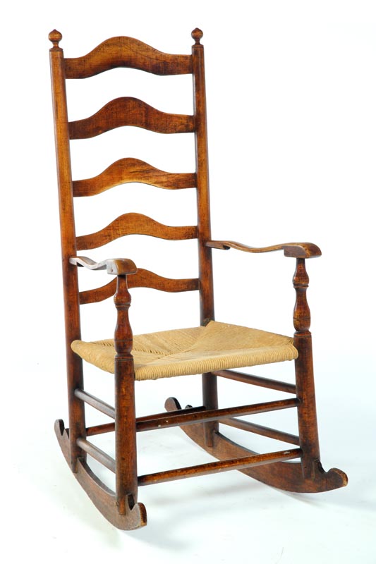 Appraisal: LADDERBACK ARMCHAIR ROCKER American th century hardwood Very good detail