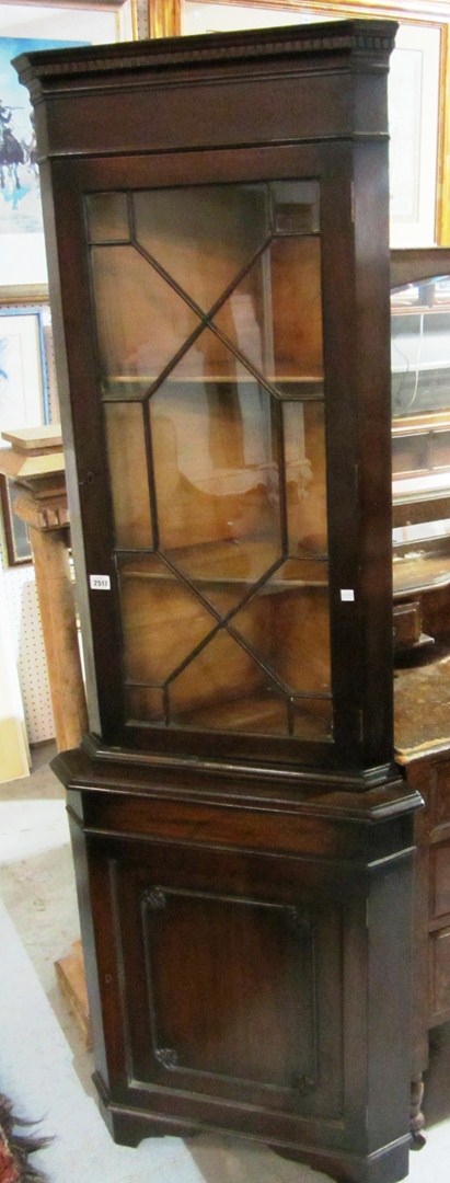 Appraisal: A th century mahogany floor standing corner cabinet